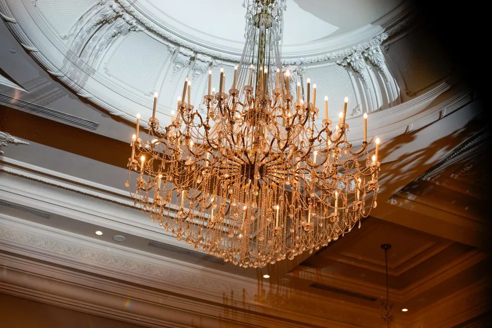 Grand chandelier over a Bergen County ballroom set for a large reception — Maximus Visions
