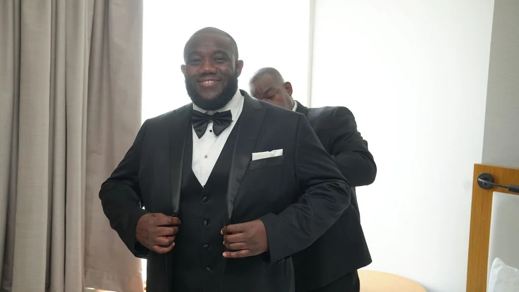 Tre sets his shawl-collar tuxedo lapels in the groom's suite — portrait by Maximus Visions, New Jersey
