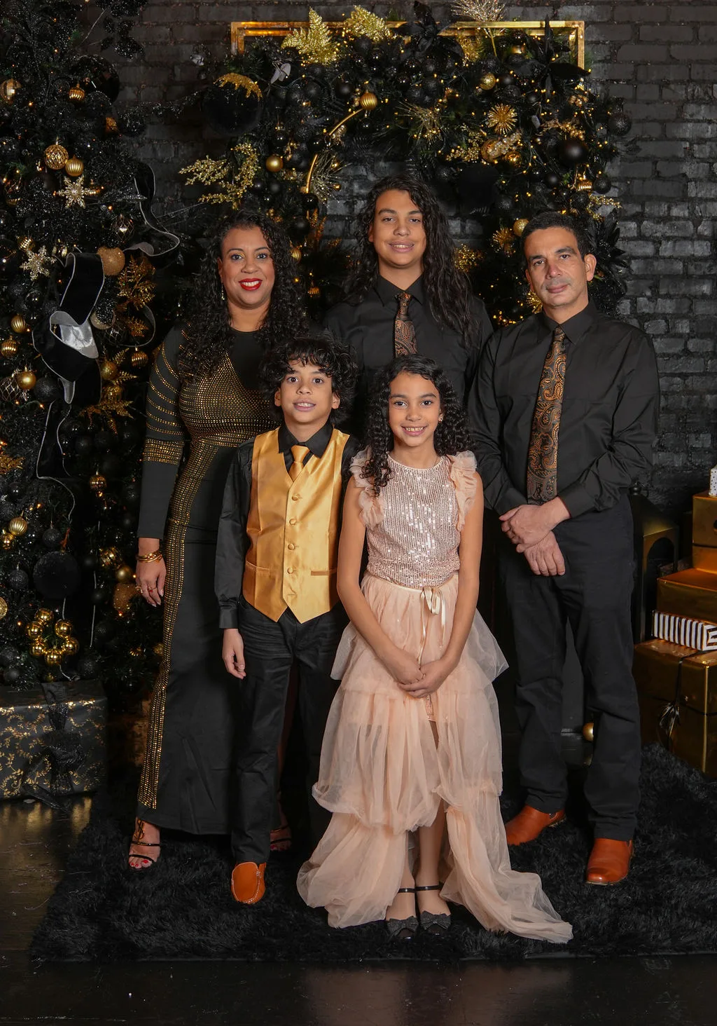 The Marlin family gathered at the black-and-gold Christmas tree, wrapped gifts at their feet — holiday studio session, Maximus Visions, New Jersey