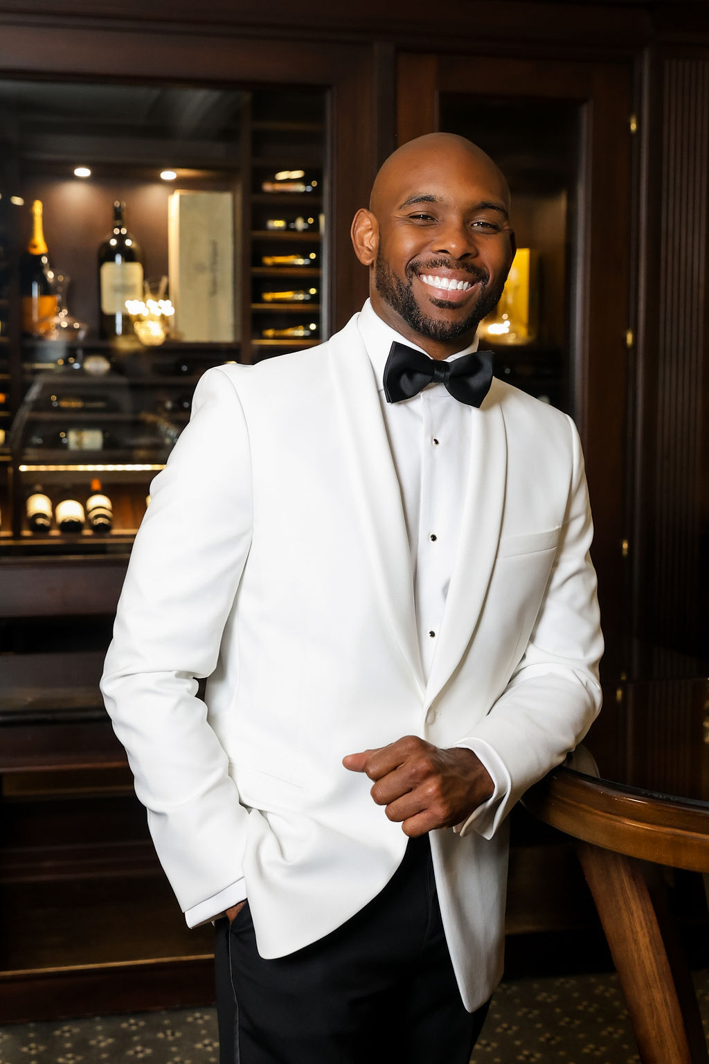 Groom smiling in white tuxedo before the ceremony at Park Chateau, NJ luxury wedding