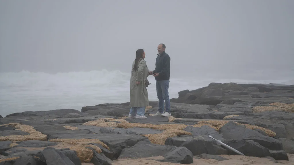 Holding hands at the edge of the jetty in the fog — moments before the question, New Jersey