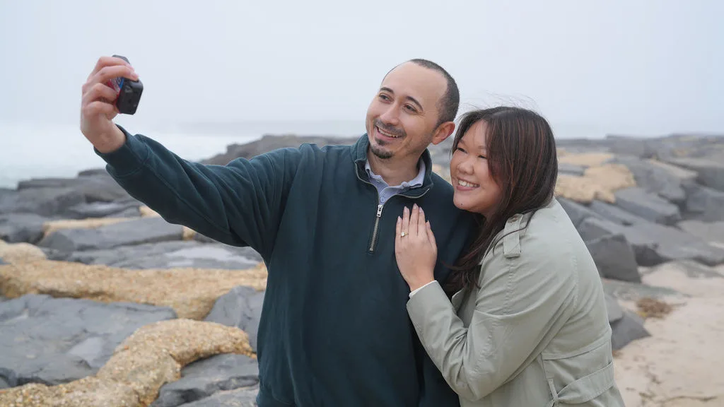 The first selfie as an engaged couple, taken on the jetty with the ring already on her hand — New Jersey shore
